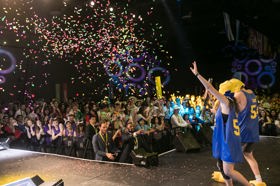 Group of people celebrating on stage