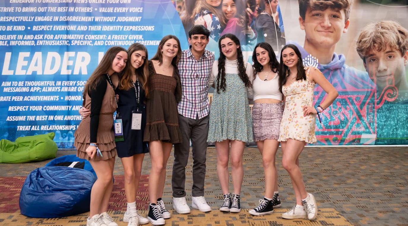 Group of diverse young people smiling at a community event