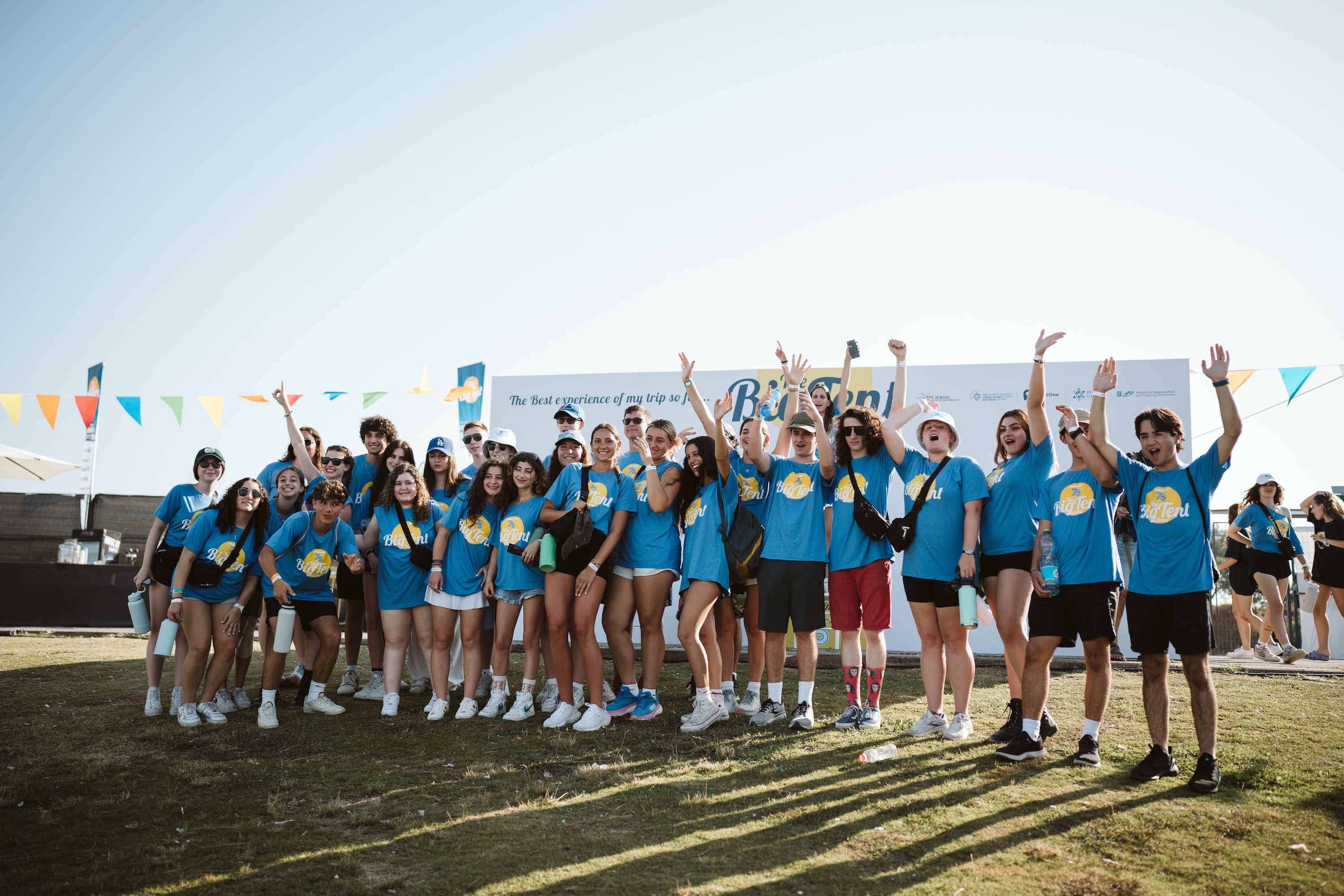 Group of diverse young people smiling at a community event