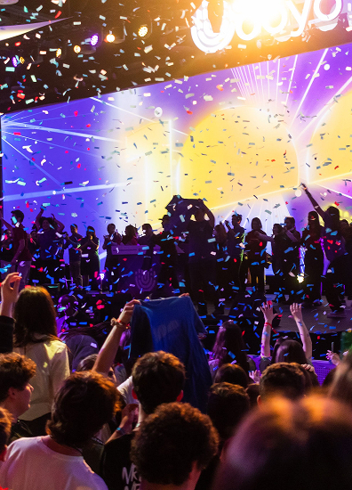 BBYO Centennial celebration with confetti, lights, and a crowd of attendees