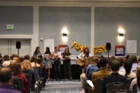 Group of people celebrating on stage