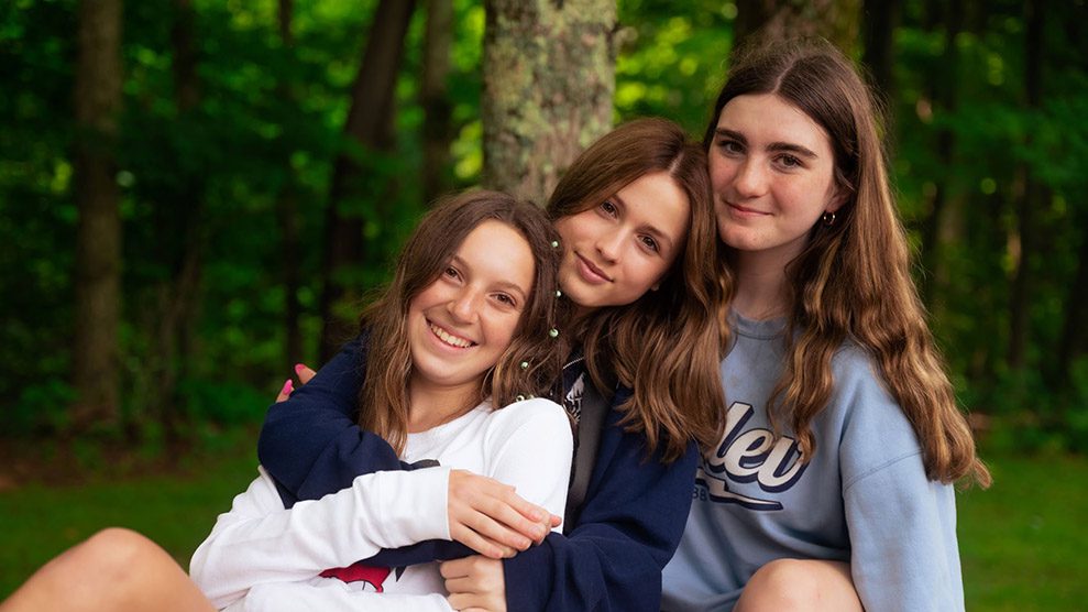 Three friends sitting on a hammock